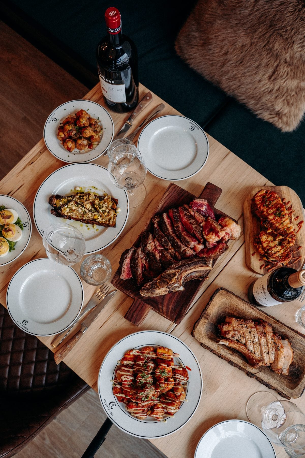 Table dressée avec une bouteille de vin dans la salle du Gueuleton, Mile-End